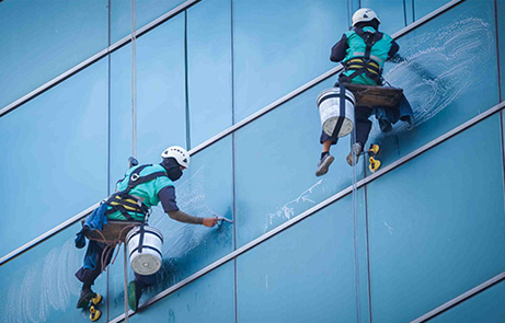 trabajadores limpiando fachada